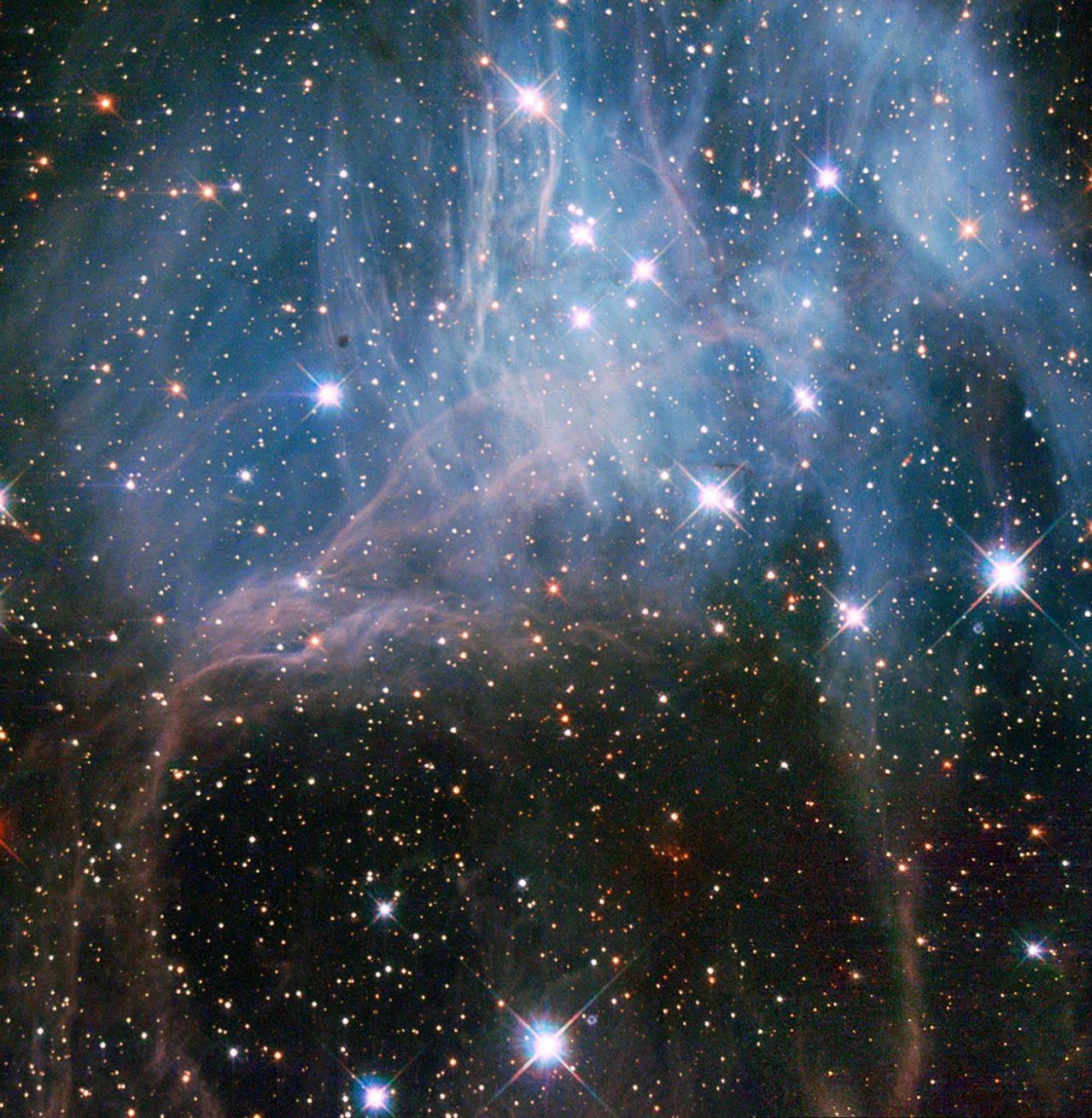 A dozen or so bright stars peer through a blue/lavender haze in the top half of the image