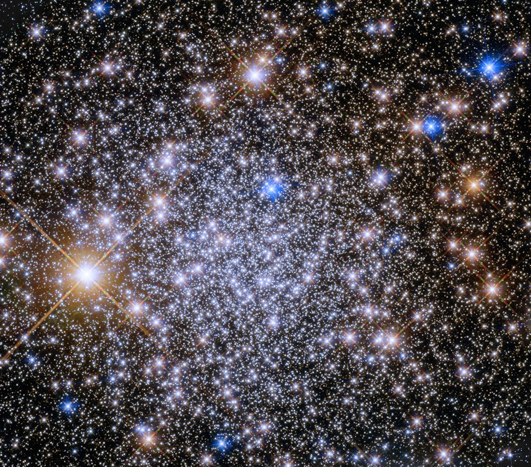 Bright blue-white stars fill the scene with a smattering or bright yellow-white stars