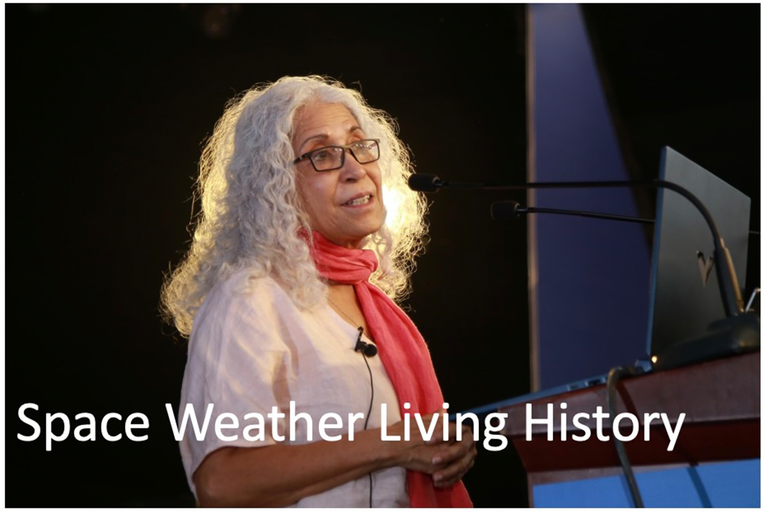 Person with white hair and a red scarf.