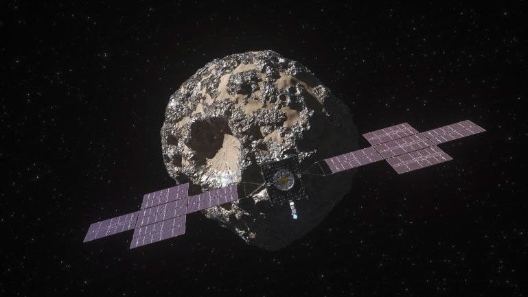 Esta ilustración, actualizada en abril de 2022, muestra la nave espacial Psyche de la NASA con el asteroide Psyche detrás.