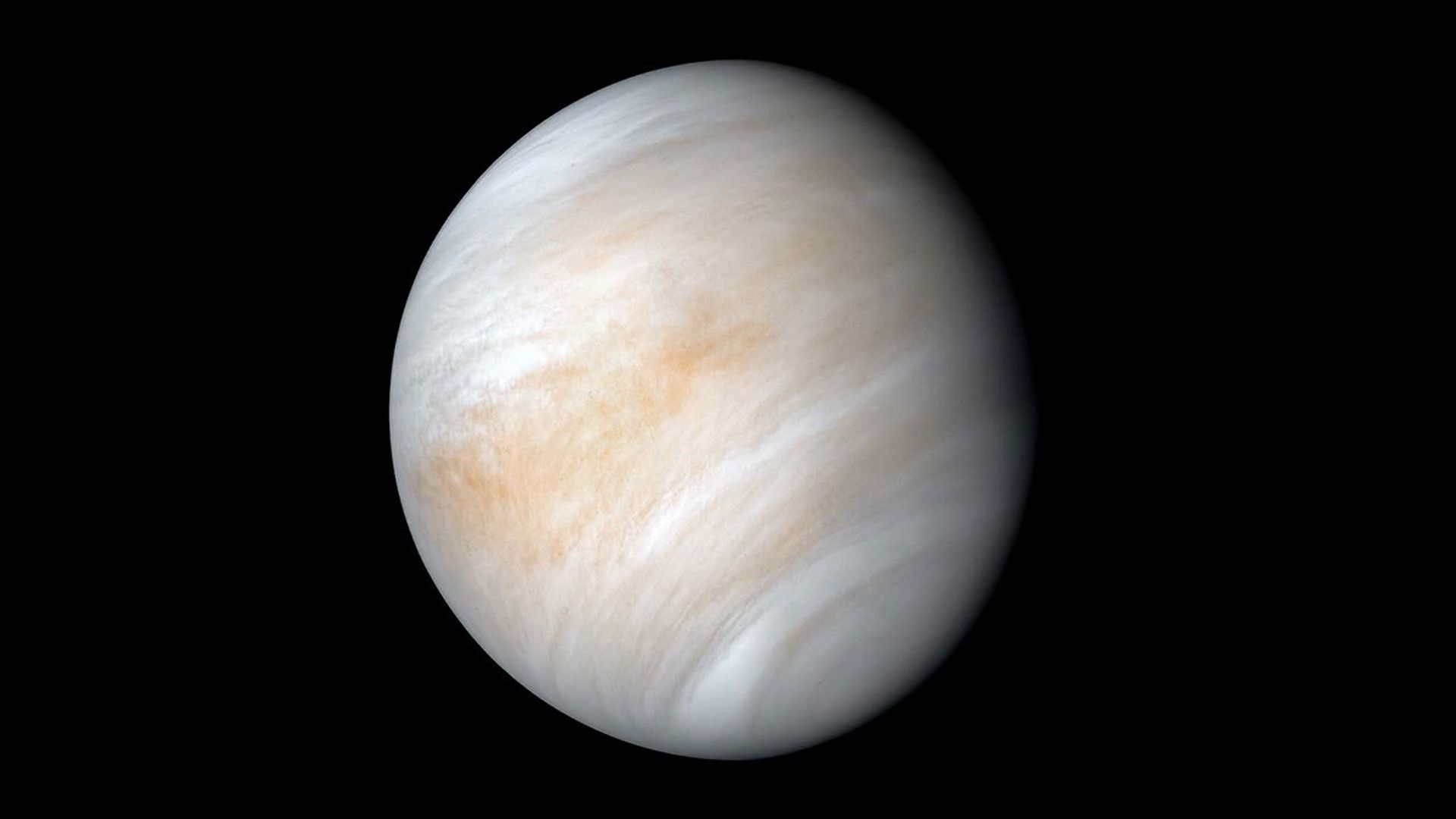 A serene-looking Venus with creamy white, and tan clouds.