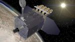 The Solar Dynamics Observatory spacecraft, like a silver rectangular box, with an antennae attached to the top. On the back are 3 cyclindrical objects and there is a large flat panel protruding from the left and right on the back.