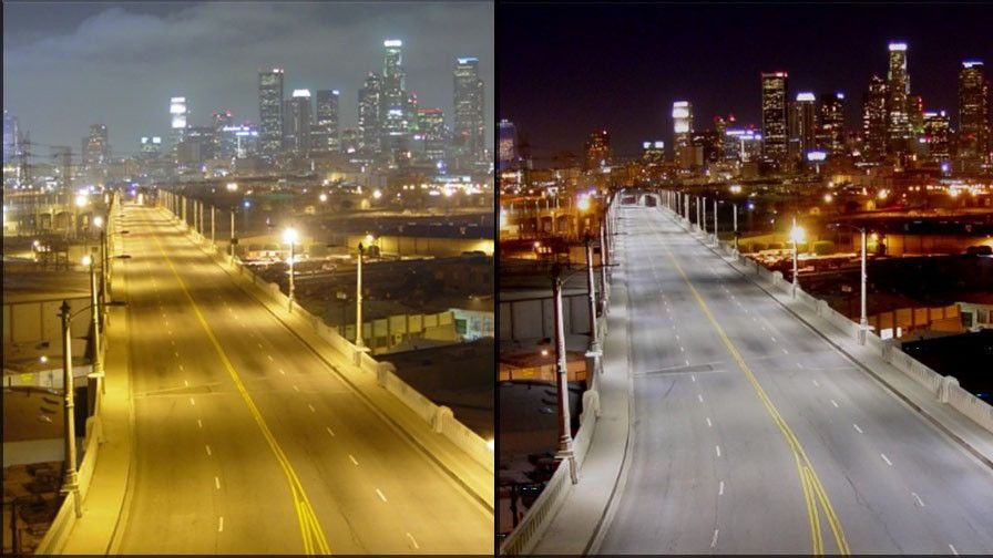 This image compares an urban street at night under two lighting types: warm, yellow sodium-vapor lights (left) and cool, white LED or metal-halide lights (right). The left appears hazy with muted colors, while the right is clearer, highlighting details and enhancing visibility.