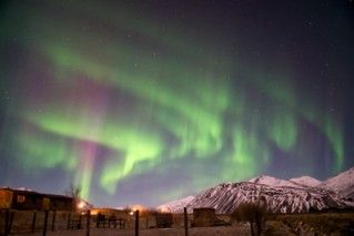 Although seen at night, the <strong>aurora</strong> <strong>borealis</strong>, or the Northern lights, is actually caused by the Sun! The light displays seen most commonly near Earth's poles are caused by the <strong>solar</strong> <strong>wind</strong> interacting with the atoms and molecules in Earth's atmosphere.