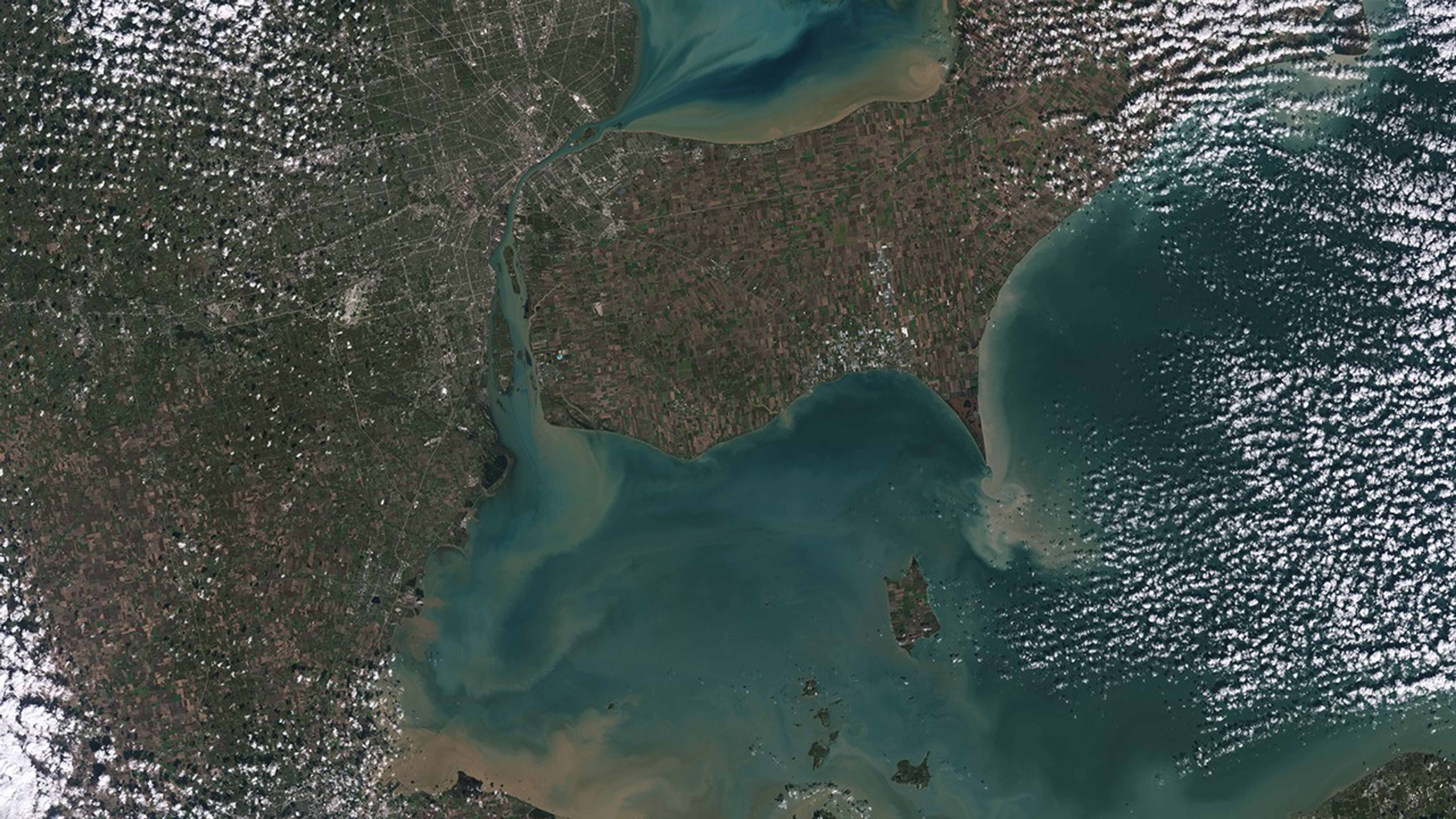 Detroit and Lake Erie -- Sediments swirl in Lake Erie and Lake St. Clair in this Landsat 9 image of both Detroit, Michigan, and Windsor, Ontario, from Oct. 31, 2021. The Great Lakes serve as sources of freshwater, recreational activity, transport, and habitat for the upper-midwestern US, and water quality remains a high priority. In warmer months, Landsat 9 observes swirls of green algae which can become harmful algal blooms. Landsat 9 will be able to help scientists and resource managers identify those blooms early, identifying areas to test further.Version without labels