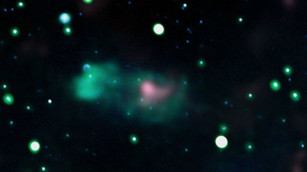 Radio observations at 408 and 1,420 megahertz, shown in blue and green, and excess gamma rays above 10 billion electron volts, shown in pink, are merged in this image.  Credit: Jayanne English (University of Manitoba), Canadian Galactic Plane Survey/DRAO, and NASA/Fermi/Fang et al. 2022