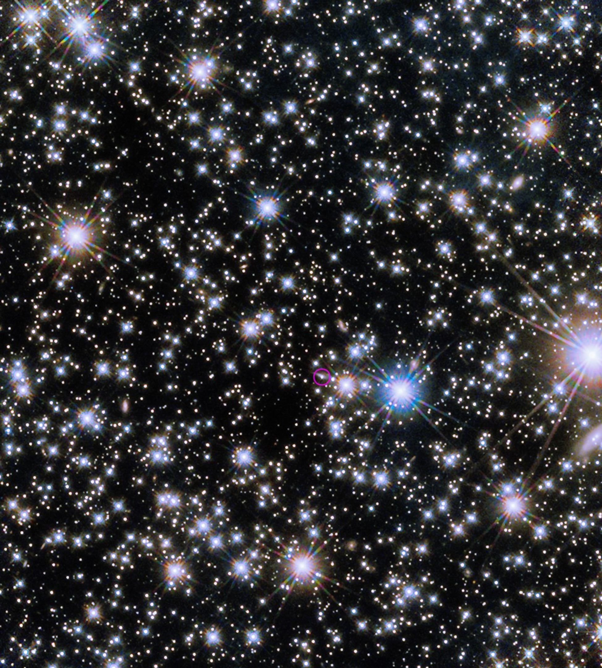 The Hubble Space Telescope’s Wide Field Camera 3 revealed the infrared afterglow (circled) of the BOAT GRB and its host galaxy, seen nearly edge-on as a sliver of light extending to upper left from the burst. This composite incorporates images taken on Nov. 8 and Dec. 4, 2022, one and two months after the eruption. Given its brightness, the burst’s afterglow may remain detectable by telescopes for several years. The picture combines three near-infrared images taken each day at wavelengths from 1 to 1.5 microns and is 2.2 arcminutes wide.Credit: NASA, ESA, CSA, STScI, A. Levan (Radboud University); Image Processing: Gladys Kober