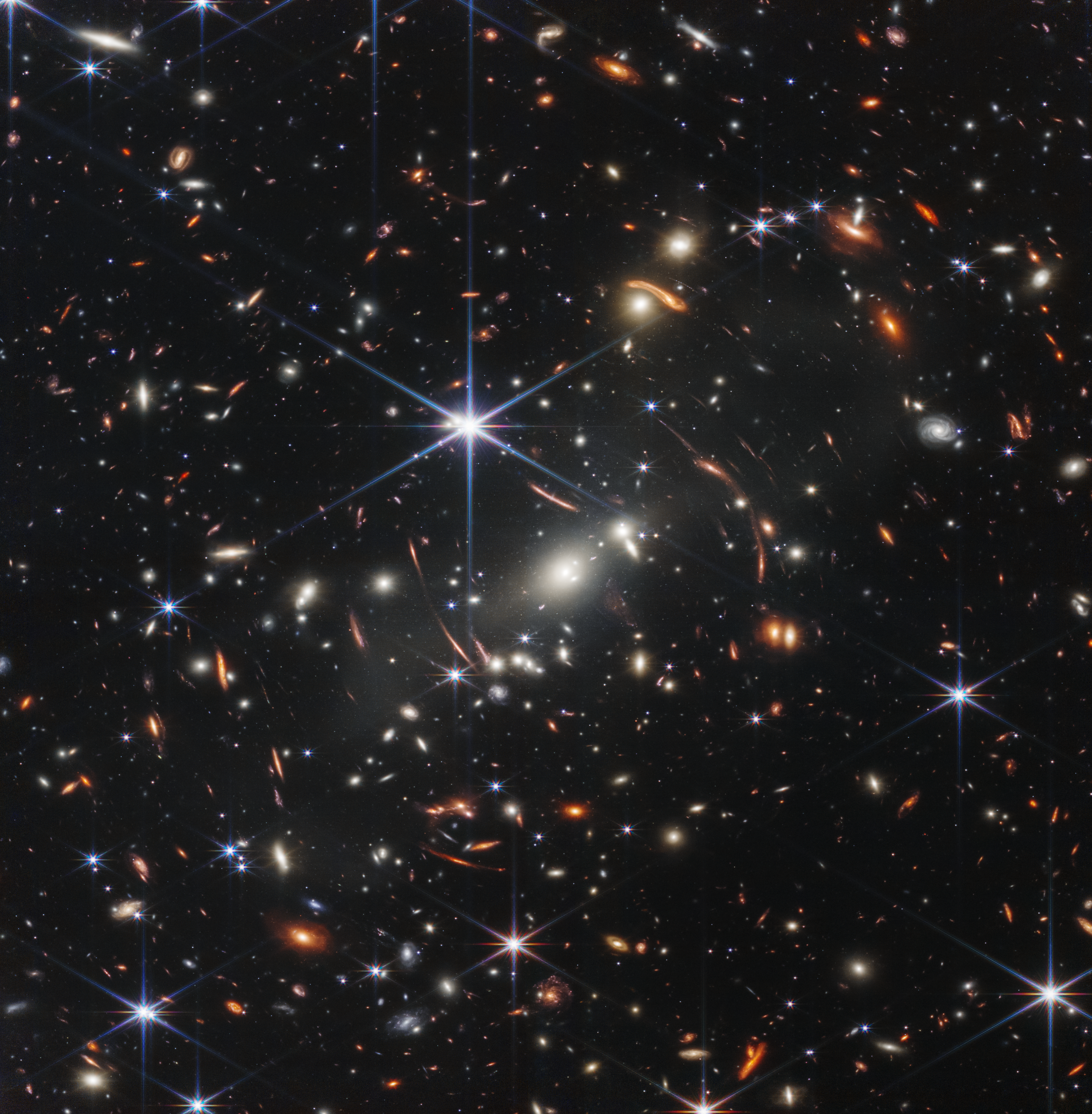 A flurry of bright white galaxies is stirring up this scene – captured in high resolution by NASA’s James Webb Space Telescope. Known as galaxy cluster SMACS 0723, the group of galaxies is also bending and warping the light from more distant galaxies behind them, stretching and repeating their appearances. Webb’s near- and mid-infrared imaging – and highly detailed data known as spectra – will allow future researchers to finely catalog the precise compositions of galaxies in the early universe, which may ultimately reshape our understanding of how galaxies changed and evolved over billions of years.