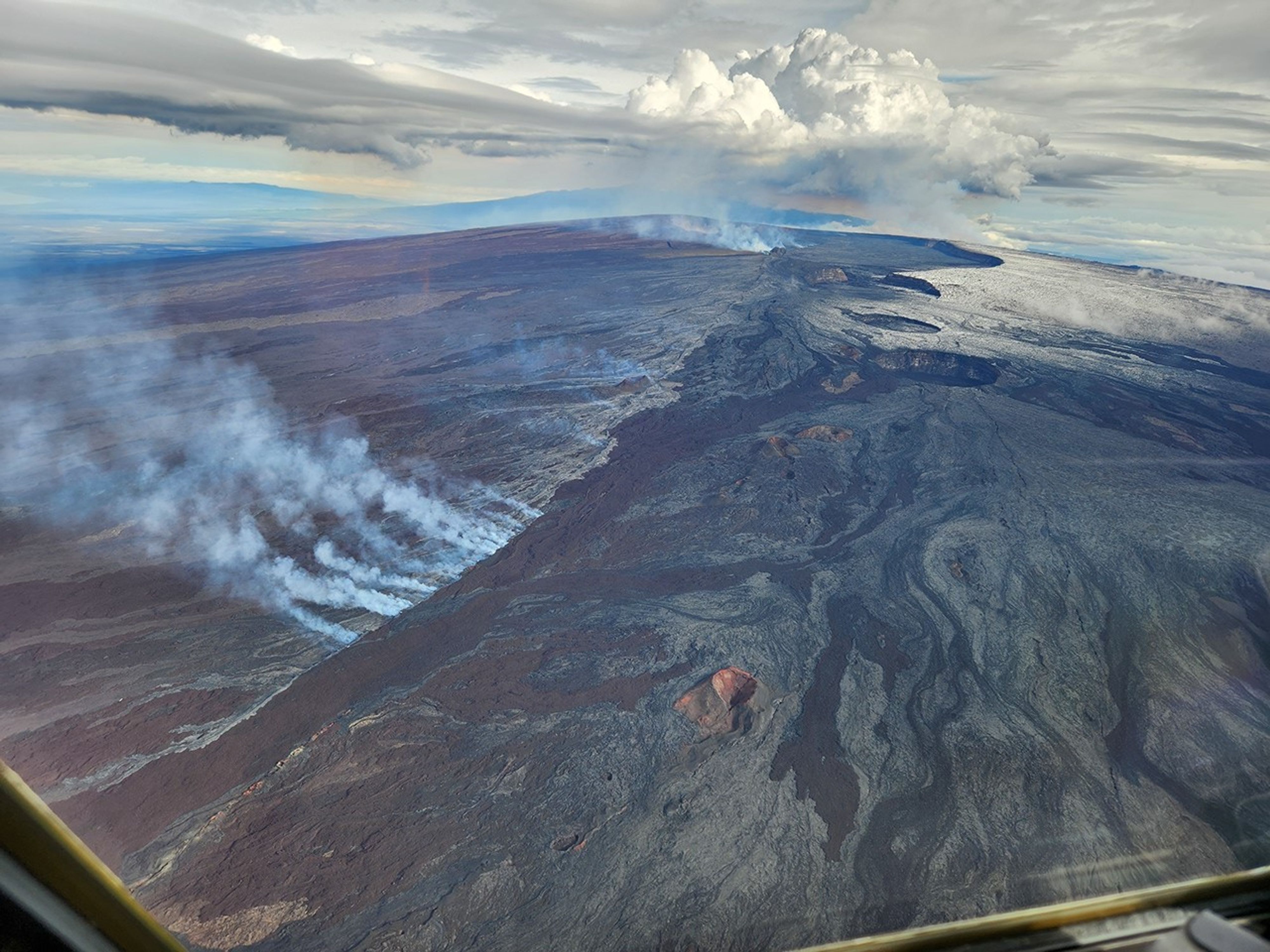Aerial view of recent lava flows near Mauna Loa’s summit in November 2022. The National Oceanic and Atmospheric Administration (NOAA) monitors greenhouse gases at Mauna Loa Observatory, which is 4 miles (6 kilometers) away from the summit crater. Despite the proximity, volcanic gases aren’t common at the observatory, and when they do happen, these temporary spikes are not included in the long-term data. The decades-long trend of increasing CO2 at Mauna Loa matches that from sampling sites all around the world. Credit: USGS/J. Schmith
