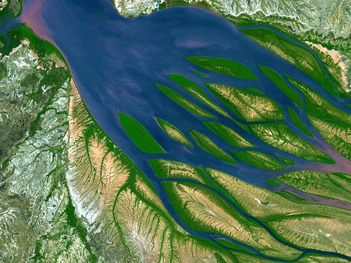 BOMBETOKA BAY: Bombetoka Bay in northwestern Madagascar is an inlet of Mozambique Channel, and is at the mouth of the Betsiboka River. Just downstream is the second largest port of Madagascar, the town of Mahajanga, a road terminus and trade center that exports sugar, coffee, spices, cassava, vegetable oils, timber and vanilla. The surrounding area abounds in extensive coffee plantations. Simulated natural color image taken by the Advanced Spaceborne Thermal Emission and Reflection Radiometer (ASTER) on August 23, 2000.