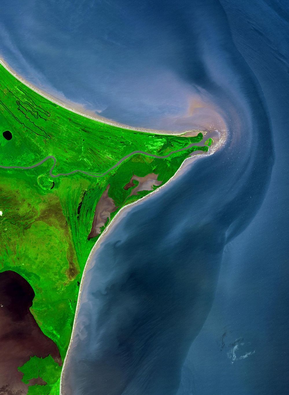 This simulated natural color image shows the Coco River, between Nicaragua and Honduras, as seen from space on December 5, 2002. As it makes its way to the Caribbean Sea, the Coco River forms the border between the two countries. The coastline, known as the Mosquito Coast, is of low relief and has plentiful water bodies, relic shorelines and high temperatures. Mosquito Coast derives its name from its principal inhabitants, the Miskito Indians, whose name was corrupted into Mosquito by European settlers. The Mosquito Indians, of whom there are several tribes, are short in stature and very dark-skinned. The first European settlement in the Mosquito country started in 1630, when agents of the English-chartered Providence Company established friendly relations with the local inhabitants. The image shown covers an area of 29 x 39 kilometers (18 x 24 miles).