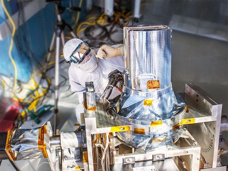 NASA engineer Chip Holloway waits for the sun to align with the Stratospheric Aerosol and Gas Experiment, or SAGE, III instrument during a clean room "sun-look" test on March 4, 2013, at NASA's Langley Research Center in Hampton, Virginia. SAGE III passed this test, successfully locking onto the sun and completing a series of measurements. SAGE III will measure aerosols, ozone, water vapor and other gases to help scientists better understand levels of ozone in the Earth's atmosphere. Credit: NASA Langley/Sean Smith.