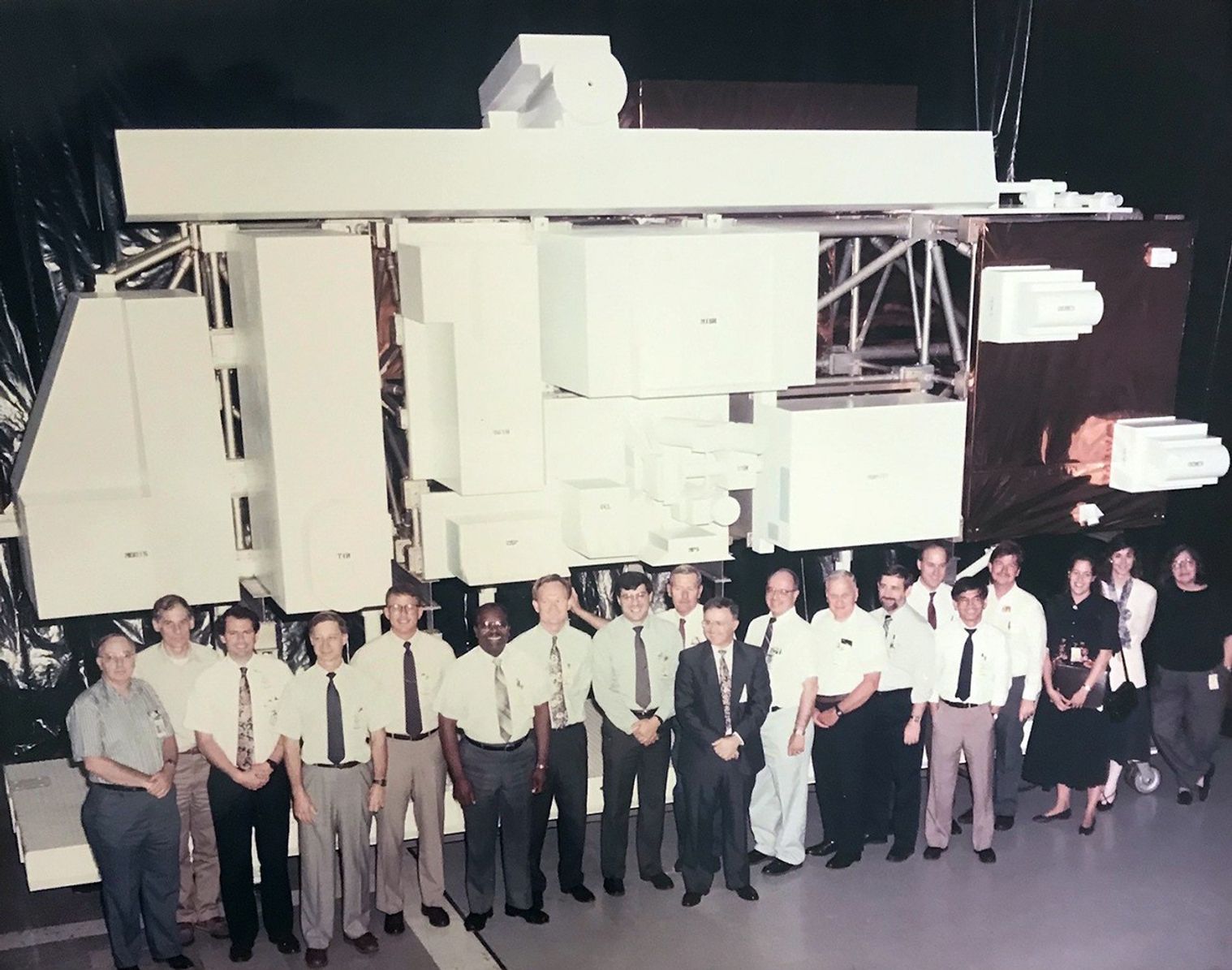NASA scientists, engineers and designers pose for a group photo in front of the Terra model.