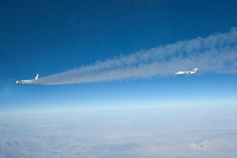 A research plane samples exhaust from NASA’s DC-8 to compare emissions from standard jet fuel with those from a biofuel blend.