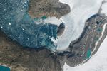 Ephemeral Arc Spans Greenland Fjord