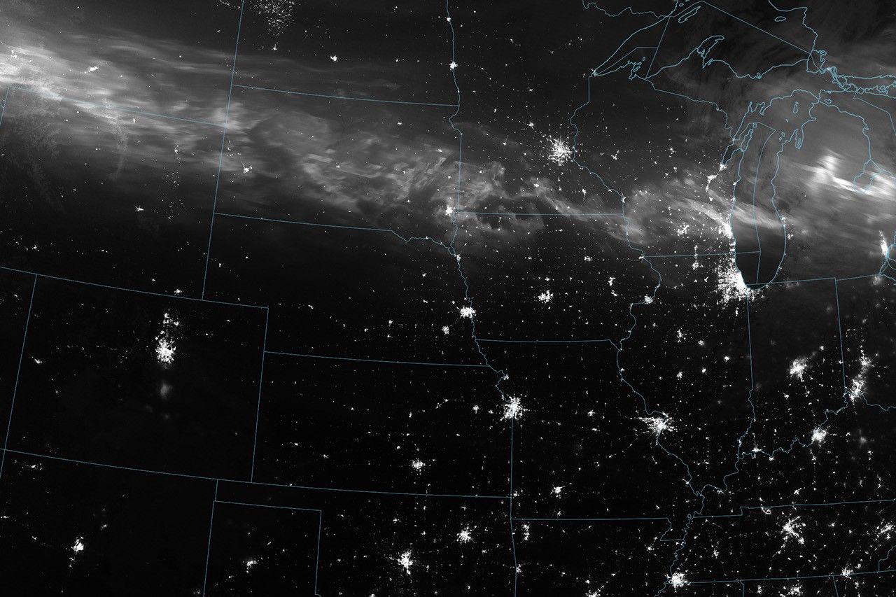 Satellite view of the aurora borealis stretching across the northern United States during the May 2024 G5 geomagnetic storm, captured by NASA's Suomi NPP satellite