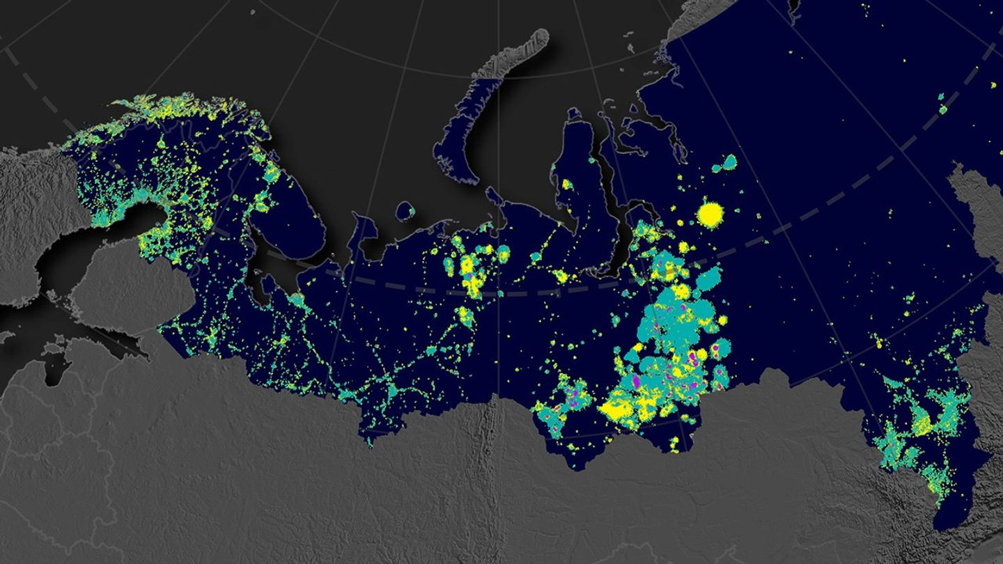 This map shows a pan-Arctic view of nighttime lights and places where the intensity of artificial lights has increased (yellow), decreased (purple), or stayed the same (green).