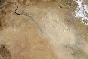 Amid a beige landscape ripples of lighter color beige dust between the Tigris and Euphrates. On the right edge of the dust region is Tikrit, and Baghdad on the southern edge of of it.