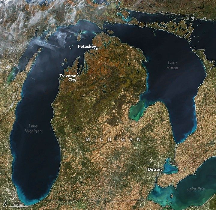 The image features the states of Michigan and surrounding lakes. Detroit is labeled in the lower right  with Traverse City and Petoskey labeled in the top left on the coast of Lake Michigan. The northern region of the state near those two cities  are a rich reddish brown color