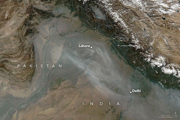 Northern Pakistan and India, including the cities Lahore and Delhi, are shown in this satellite image under a thin blanket of smoke.
