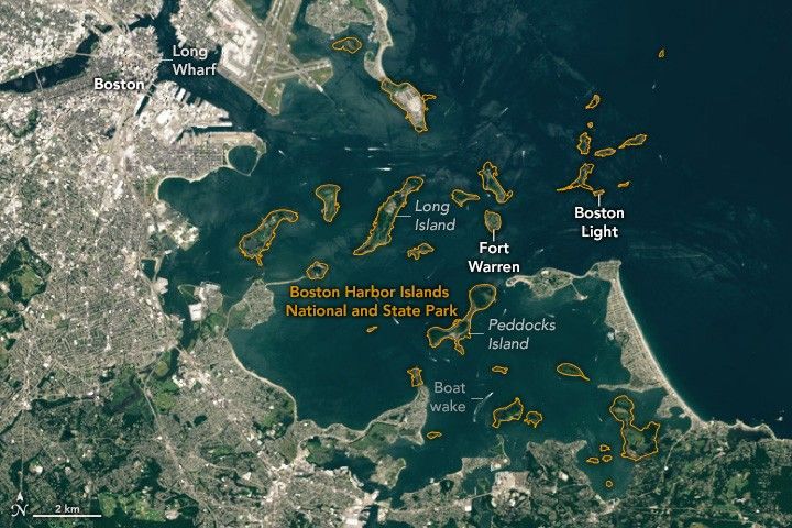 Image of Boston and the Harbor, the city center and Long Wharf is in the upper left and land wraps around in a rough arc to the lower right. There are many islands in the harbor with an orange outline around them all labeled Boston Harbor Islands National and State Park. Long island stretches vertically through the near center of the image. Fort Warren is right of that and the final islands before the open ocean includes Boston Light. Peddocks Island is one of the larger islands and located below Fort Warren.