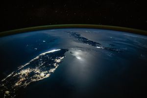 City Lights Glow Along Moonlit Waters