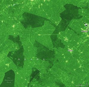 A vibrant green landscape is broken up by a few precise borders of darker green foliage. In the bottom left one of those areas is Bia National Park, darker in color than any other part of the picture. A few spots and streaks appear a very light green or yellow as they are regions cleared for human settlement, Kenyasi and Goaso on the right side of the image are the two labelled areas where this is seen.