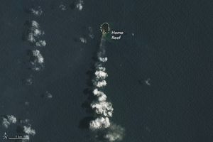 A small island, labeled home reef, is the origin of a thin translucent smoke stream that becomes puffy clouds as it streams toward the bottom of the image.