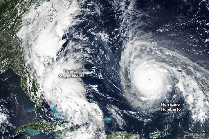 Two sets of swirling clouds over the rich blue waters of the Atlantic Ocean, with Tropical Storm Imelda blocking the lower East Coast but just off Florida's coastline.