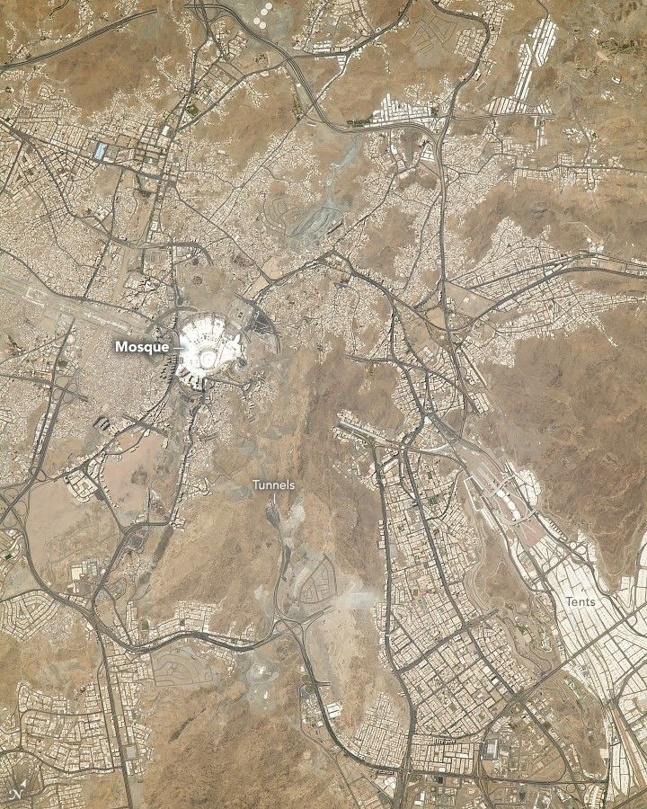 The light brown sandy region centers a bright white building labelled Mosque. There are sprawling major roadways across the region with significant human settlements around them. In the lower part of the image are tunnels, directly below the Mosque. and the lower right shows large blocks of white labeled tents.