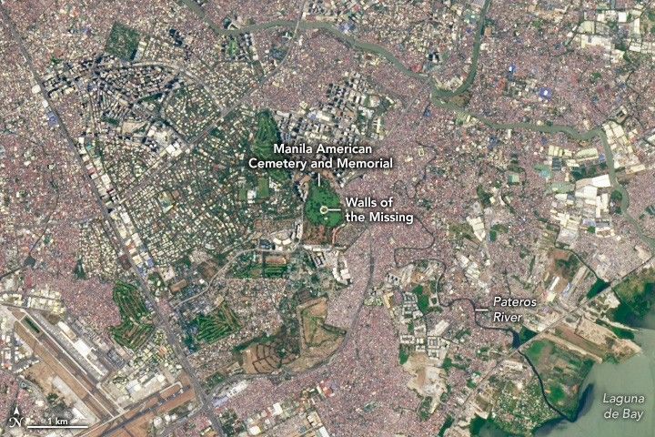 amid a densely settled region the image centers on a green spot labeled walls of the missing and Manila American Cemetery and Memorial. A golf course's extends the green area to the left of center. At the bottom right is Laguna with Pateros River Meandering to it from the urban area.