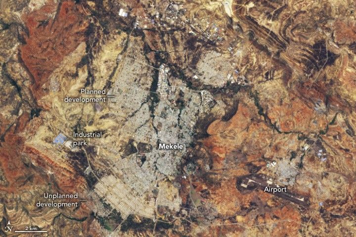 The image shows the expanding city of Mekele which includes planned development and an industrial park on the left side of the city. The surrounding landscape primarily appears shades of yellow and orange.