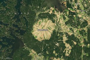 In Finland, a circular region of land is completely divided into crop fields and labelled Söderfjärden. An airport is in the upper right corner. To the left of Söderfjärden the land is broken up by waterways and small islands covered in dense dark green foliage. There are more fields of crops between Söderfjärden and the airport that seem to follow valley's leaving higher elevations covered in dark green foliage. The fields are all a light green to beige color.