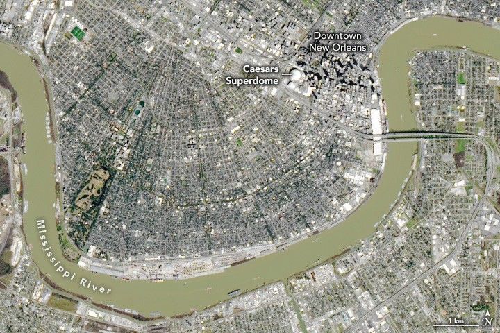 A very built up landscape along a meander in the Missisippi River includes Downtown New Orleans and the round top of the Ceasars Superdome.