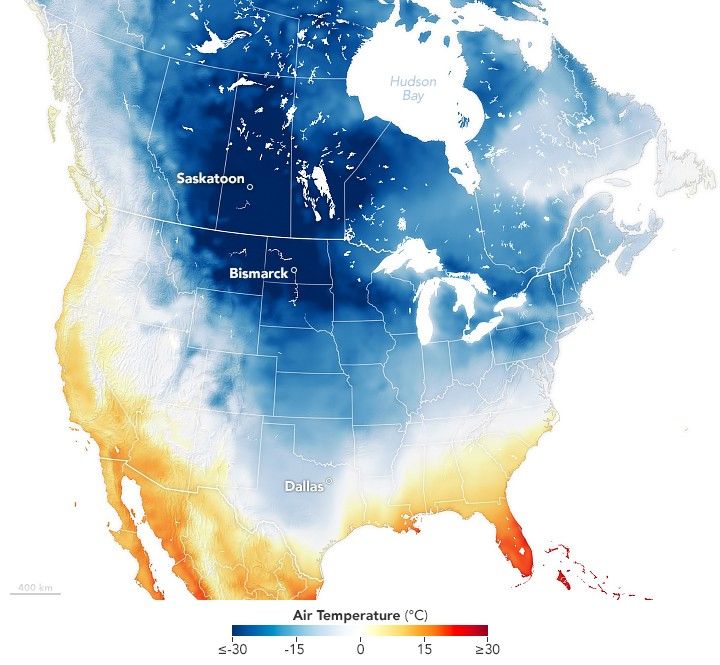 Map of North America with a temperature gradient overlay and state boundary lines. Saskatoon, Bismark and Dallas are all labelled. The color gradient ranges from -30 degrees C to positive 30 C, with white being 0 and cold being shades of blue, warm, shades of red. The center of north America is all in the blue shade, with a significant portion showing up in white. The labeled cities are all in a distinctly blue area of the map.
