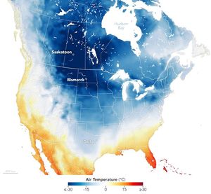 Map of North America with a temperature gradient overlay and state boundary lines. Saskatoon, Bismark and Dallas are all labelled. The color gradient ranges from -30 degrees C to positive 30 C, with white being 0 and cold being shades of blue, warm, shades of red. The center of north America is all in the blue shade, with a significant portion showing up in white. The labeled cities are all in a distinctly blue area of the map.