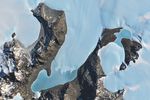 The image is centered on Anuchin and Ober-See glaciers in Antarctica. They appear as bright white patches separated by brown rocky ridges. Both glaciers have ice-covered meltwater lakes draining from their termini. Lake Unter-See is the larger of the two lakes.