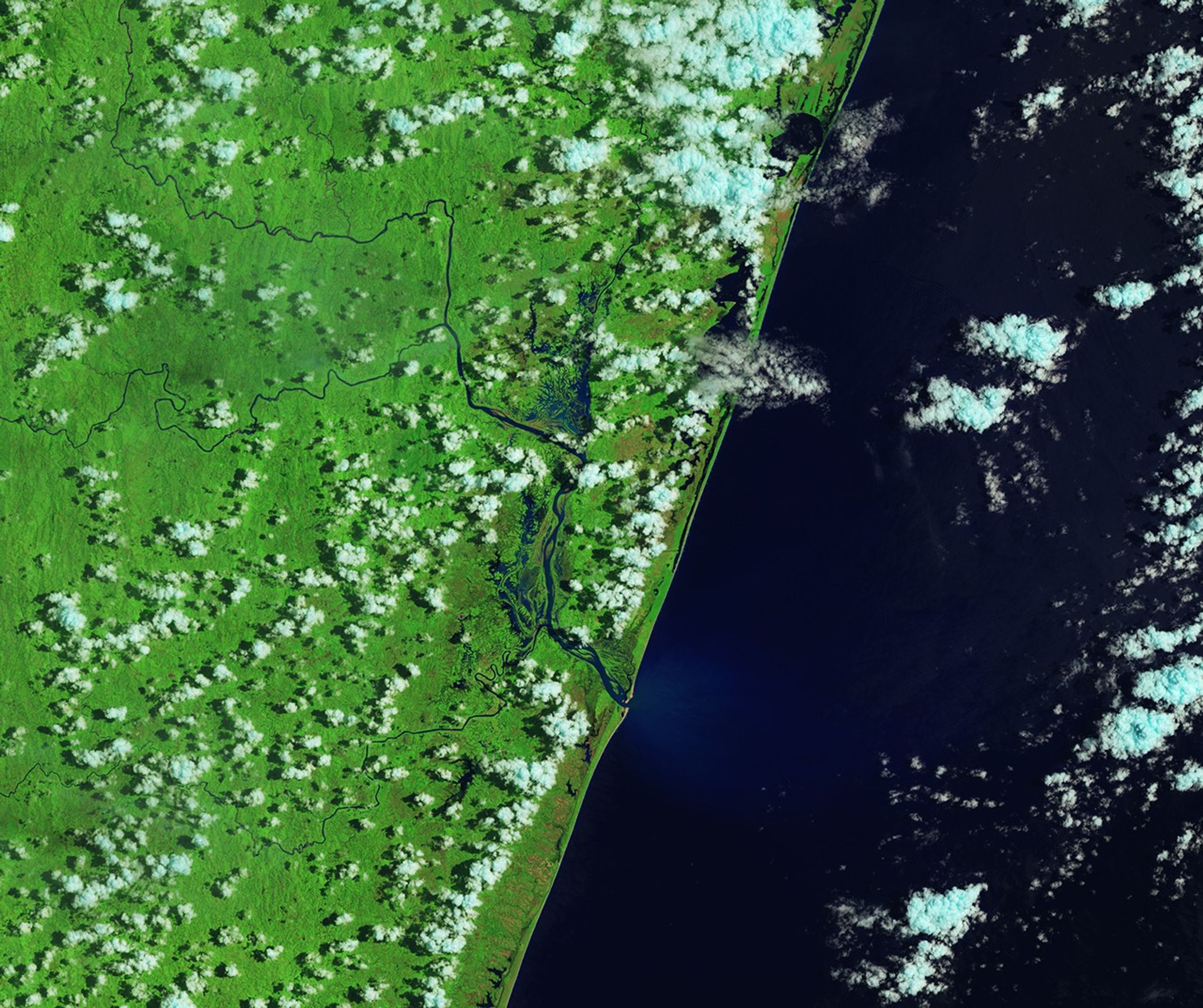 In a false-color image acquired after the flooding, waterways appear much wider, and floodwater covers large portions of the landscape west of the two rivers, both north and south of Brickaville.