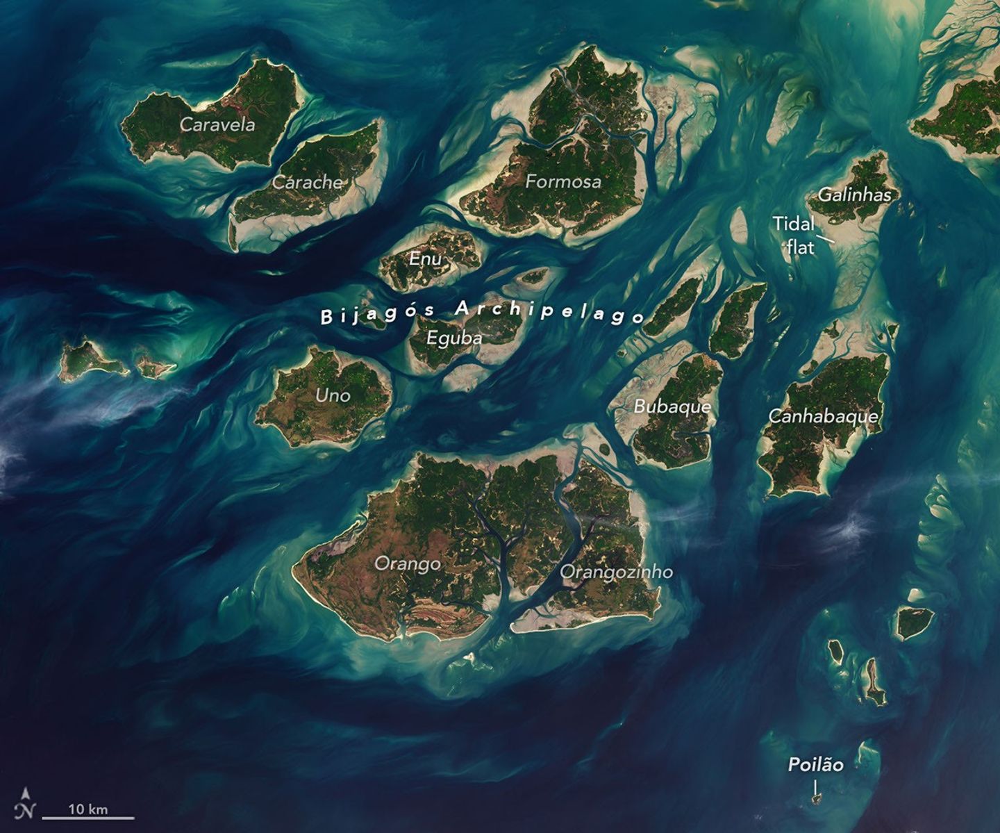 A satellite image shows a cluster of green islands surrounded by beige sand flats and networks of channels full of dark blue water.