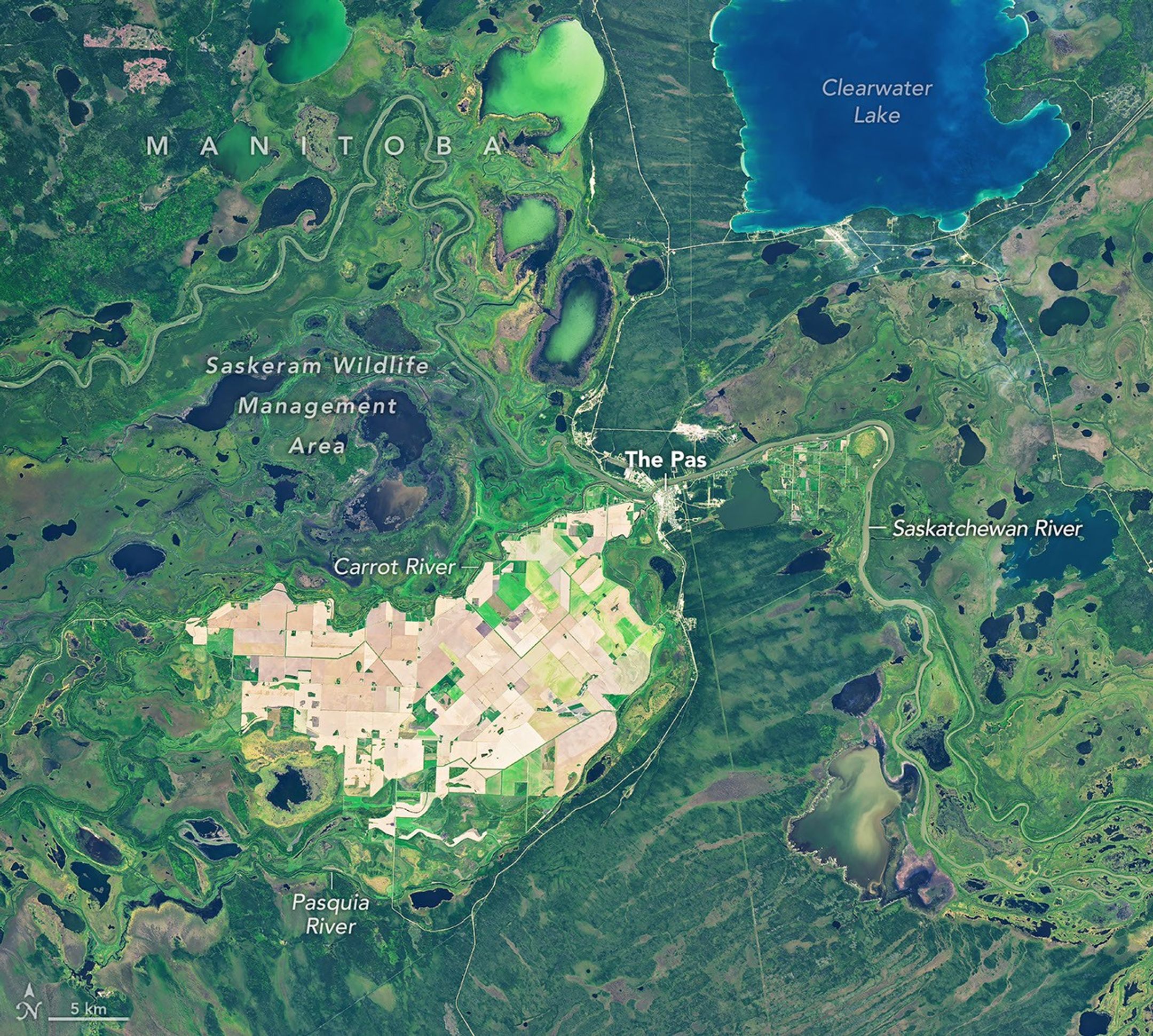 The same area in autumn shows many of the farm fields are now brown, and the surrounding wetlands hold less water.