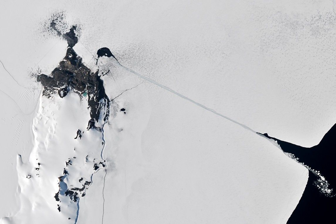 A satellite image of the same area shows a completed channel cut by an icebreaker through the sea ice. The ship channel stretches about 10 kilometers from open water on the right to McMurdo Station on the left.