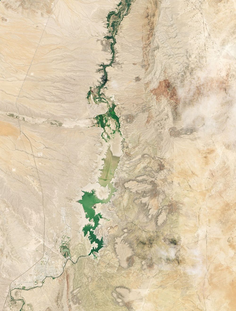 A three-part image shows Elephant Butte Reservoir in New Mexico in 1994, 2013, and 2026. In 1994, on the left, the lake is nearly full. In the other two years, it is close to empty.