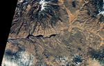 The first of a pair of satellite images shows the reservoir in November 2017, when water levels were relatively high and its color was mostly blue.