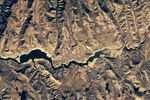 The second image in the pair shows the same part of the reservoir in November 2021, when water levels were much lower and its color was much greener.