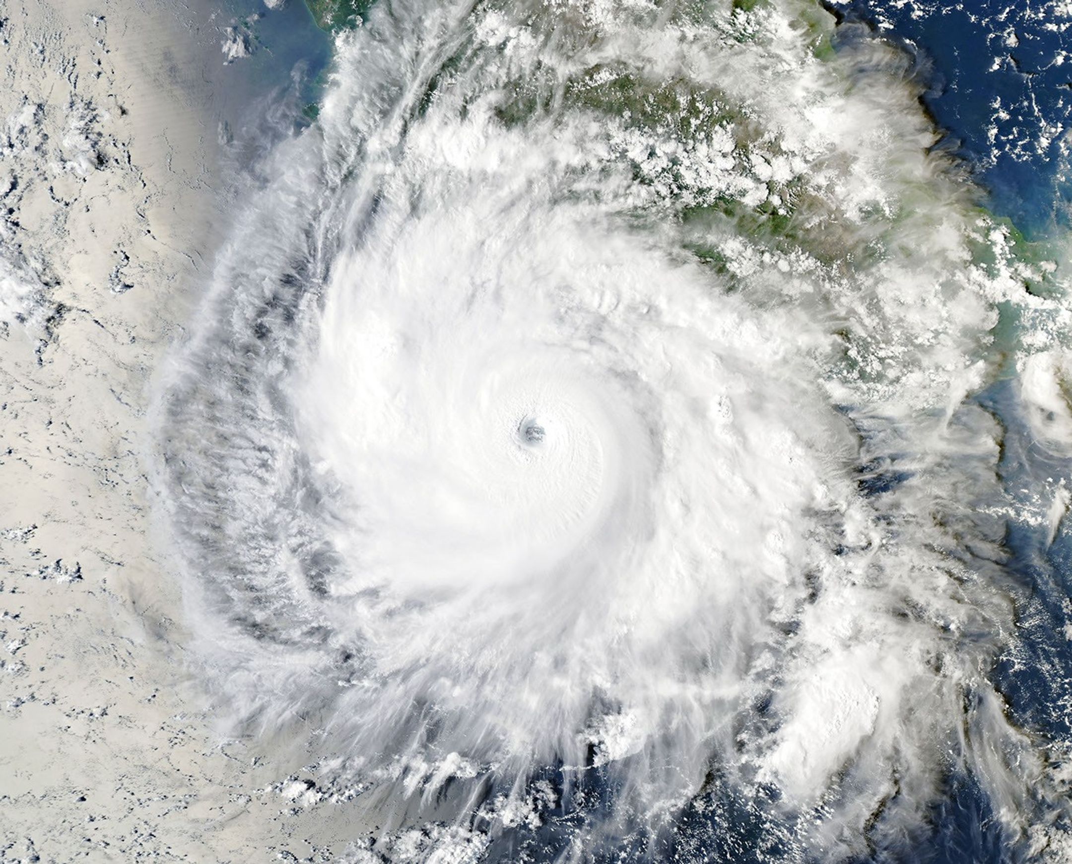 Hurricane Polo, with a well-defined eye, swirls over the Pacific Ocean off the coast of Mexico. The storm was positioned just south of Acapulco, with its outer cloud bands extending inland toward Mexico City.