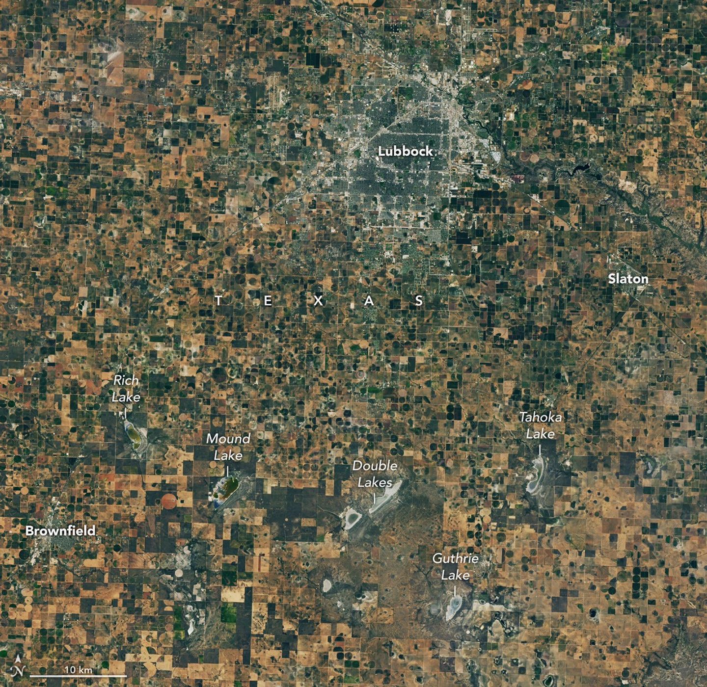 A satellite image of farmland around Lubbock, Texas, on September 22, 2025, features a patchwork of green and brown agricultural fields and several playa lakes with varying amounts of water.