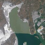 A satellite image of the Great Salt Lake shoreline in 2011, when higher water levels cover areas where mounds became visible in 2025.