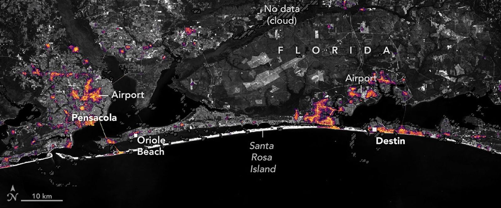 Nighttime lights along the Florida Panhandle coast on October 11, 2026, after Hurricane Isaias, with fewer and dimmer lights in Pensacola and Destin …