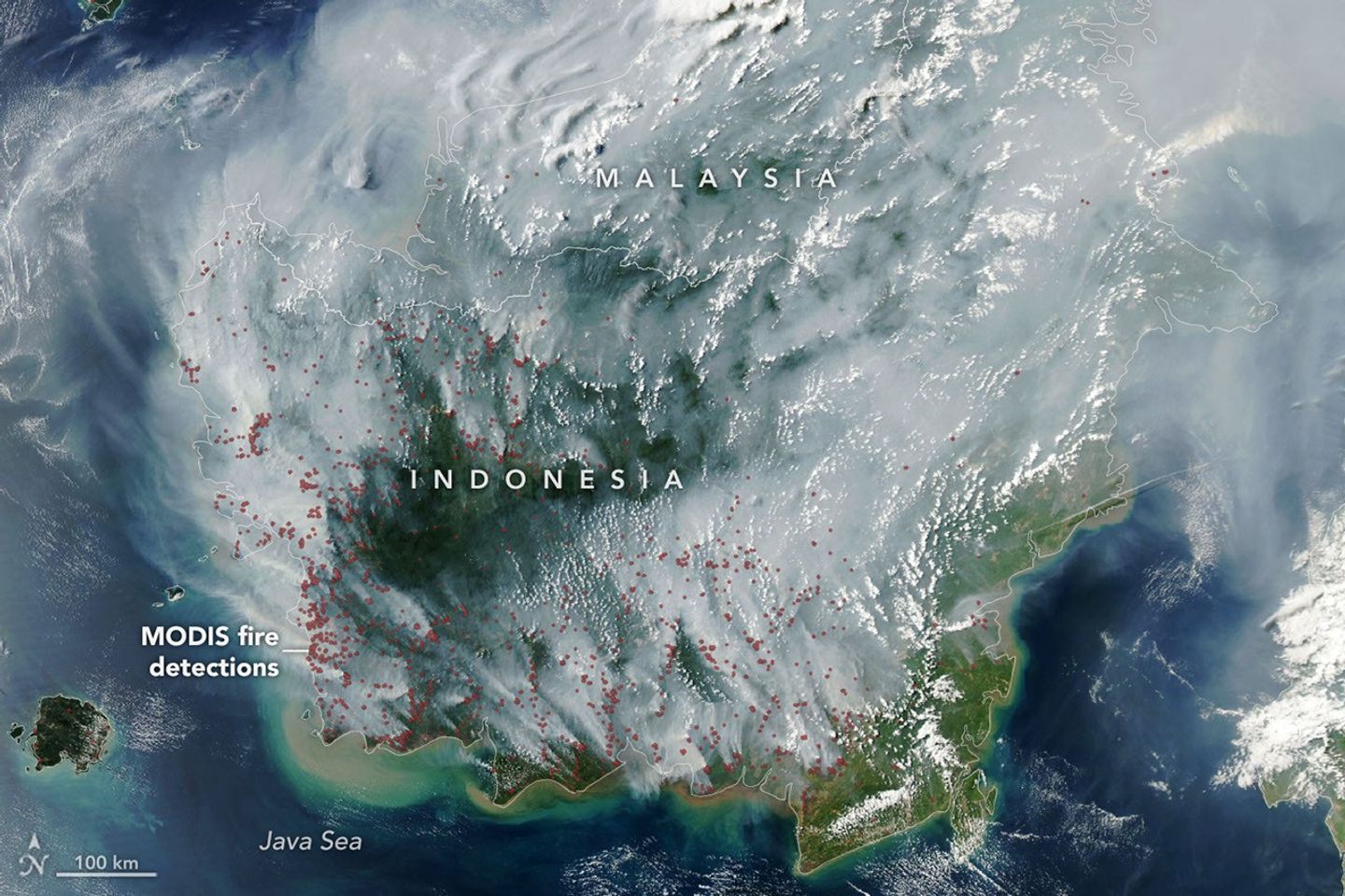 The locations of MODIS fire detections are depicted with small red circles. Most are visible on the southern side of the island.