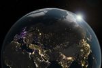 A data visualization shows changes in artificial light at night across the Eastern Hemisphere from 2014 to 2022, with increases shown in yellow and orange and decreases shown in purple.